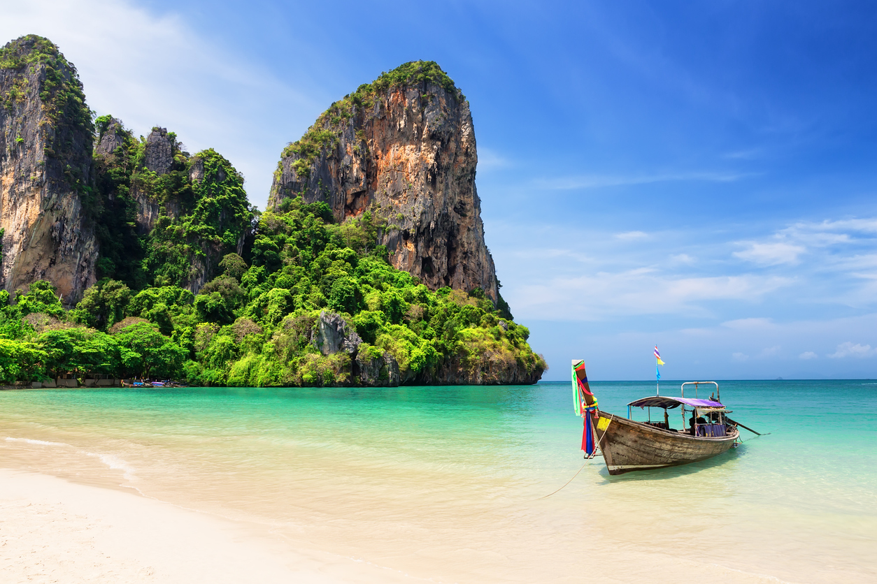 Thai traditional wooden longtail boat and beautiful sand beach